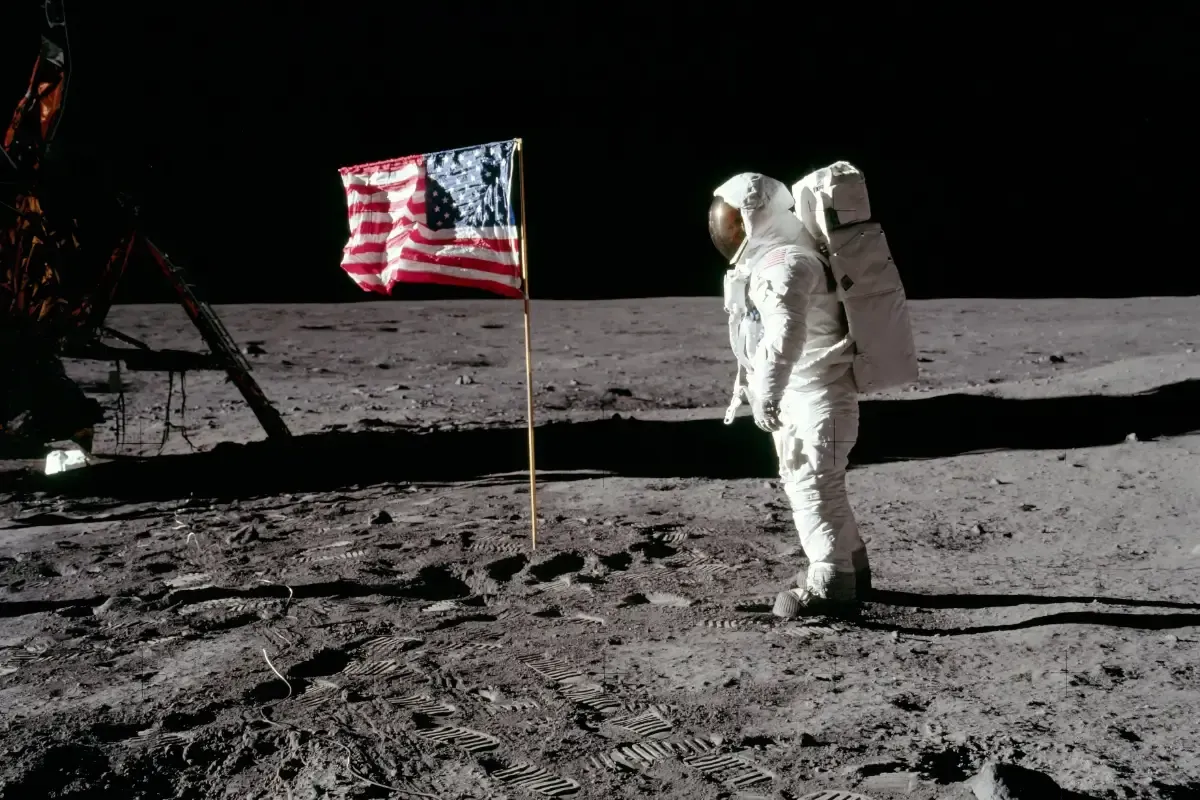 On the moon during Apollo 11, astronaut Buzz Aldrin is facing the U.S. flag