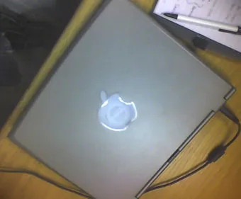A Dell Latitude notebook computer with an Apple decal over the Dell logo
