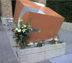 Flowers are laid at the entrance of the CNET building in memory of James Kim
