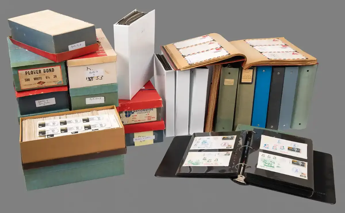 Roughly twenty shoe boxes and binders, some open to display space-related envelopes and stamps