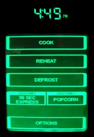 A GE Spacemaker 2.0 touch panel. It shows the time and virtual buttons for “Cook,” “Reheat,” “Defrost,” “30 Sec Express,” “Popcorn,” and “Options.”