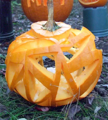 A pumpkin carved so that there’s more empty space than pumpkin