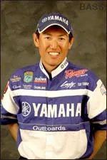 Takahiro Omori in competitive-fishing garb adorned with sponsor logos