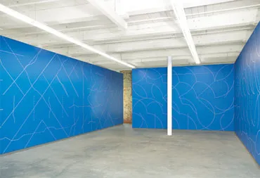 Sol LeWitt’s “Wall Drawing 146A”: the walls of a room are painted blue; thin light lines trace patterns across the walls
