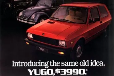 A print ad with a red Yugo car in the foreground and a Volkswagen Beetle in the background. The text says: “Introducing the same old idea. YUGO $3990.”